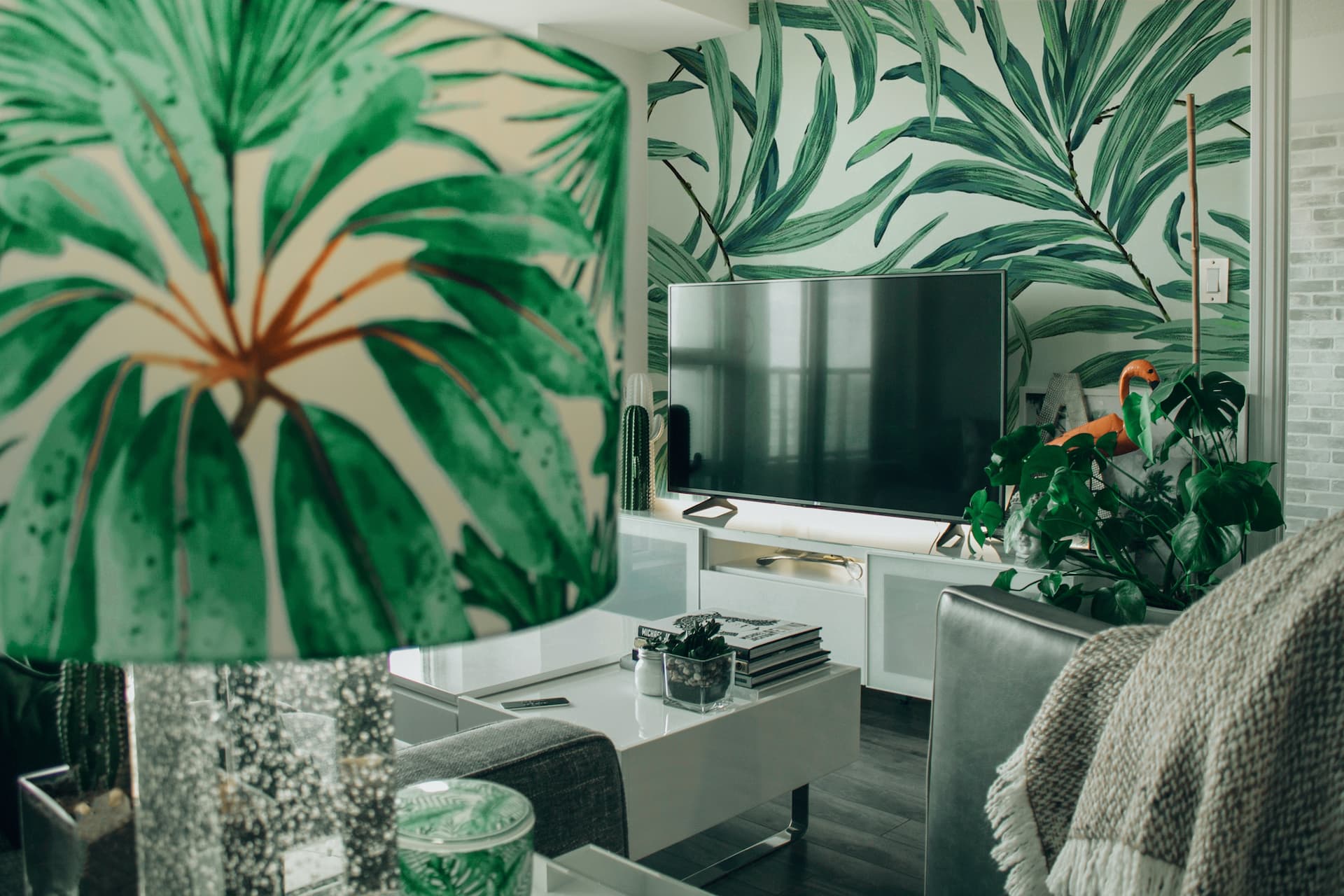 Papel pintado estilo tropical en la pared de un salón.